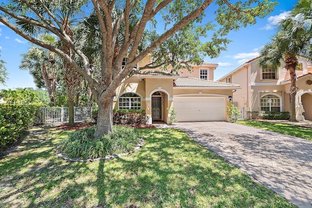 4474 Thornwood Cir, Palm Beach Gardens, FL 33418 - mediterranean / spanish-style home featuring stucco siding, a garage, driveway, and a tile roof