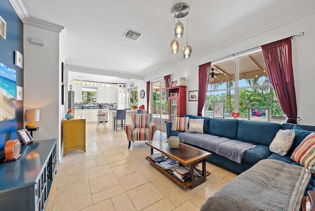 4474 Thornwood Cir, Palm Beach Gardens, FL 33418 - living area featuring crown molding, a textured ceiling, and stone tile floors