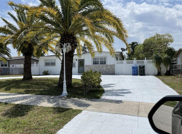 view of front of property with stucco siding and fence