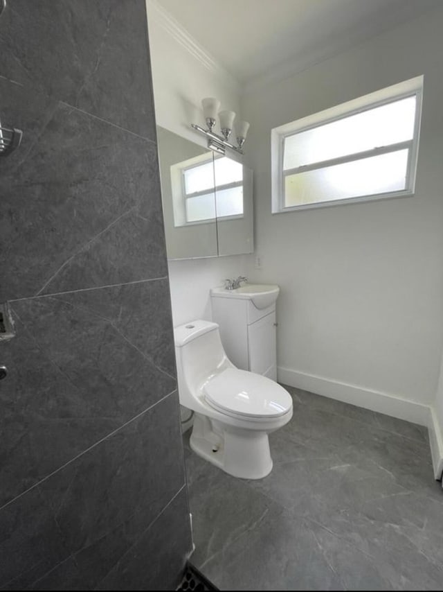 bathroom featuring toilet, baseboards, ornamental molding, and vanity
