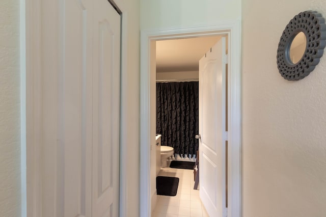 bathroom with toilet and tile patterned floors