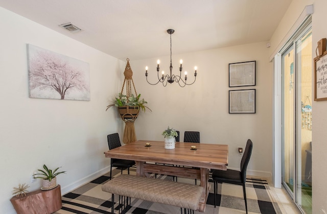 dining room with visible vents, baseboards, and a notable chandelier