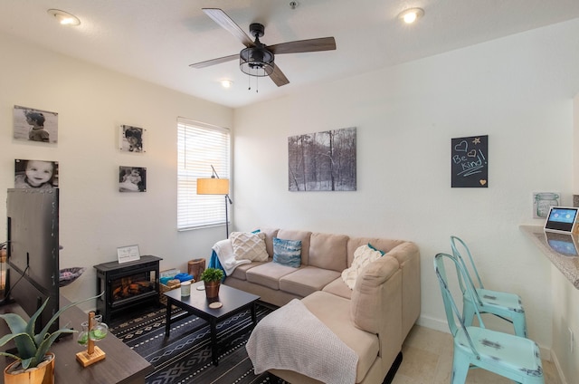 living room with baseboards and a ceiling fan