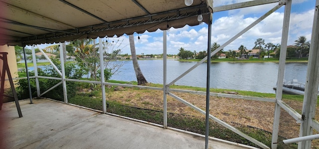 unfurnished sunroom with a water view