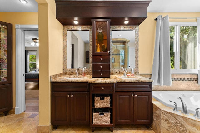 bathroom featuring a sink, double vanity, a stall shower, and a garden tub
