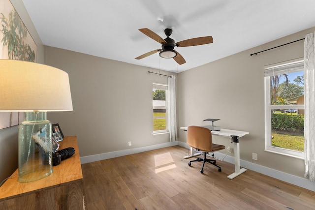 home office with baseboards, a ceiling fan, and wood finished floors