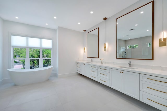 full bath featuring double vanity, a freestanding tub, a tile shower, a sink, and recessed lighting