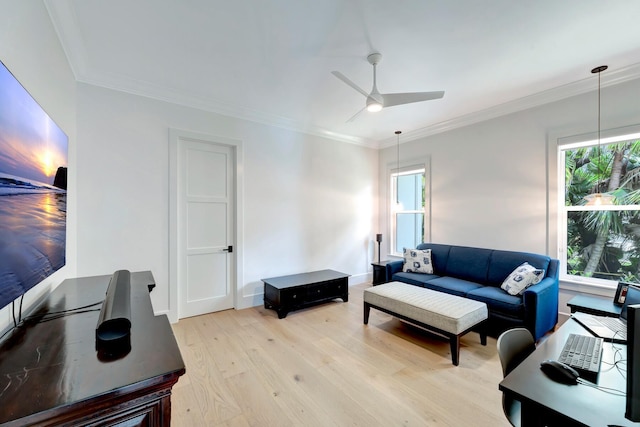 living room with crown molding, light wood-style flooring, and ceiling fan