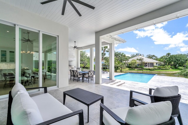 view of patio / terrace featuring a water view, ceiling fan, an outdoor living space, and an outdoor pool