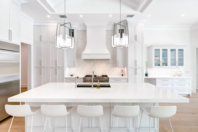 kitchen featuring backsplash, high quality appliances, a chandelier, and custom exhaust hood