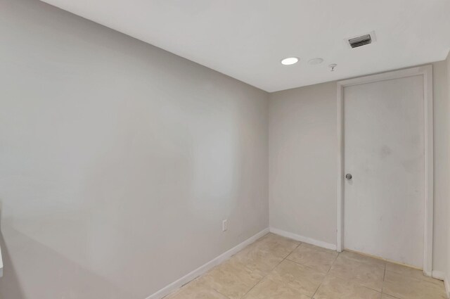 unfurnished room with light tile patterned flooring, baseboards, and visible vents