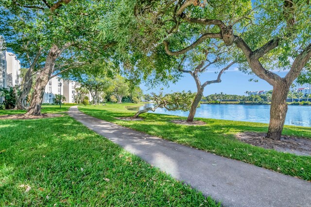 surrounding community featuring a water view and a yard
