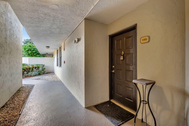 entrance to property featuring stucco siding