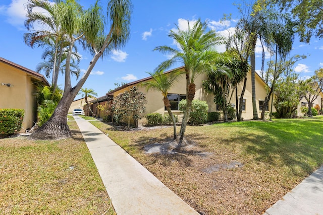 exterior space featuring a front yard and stucco siding