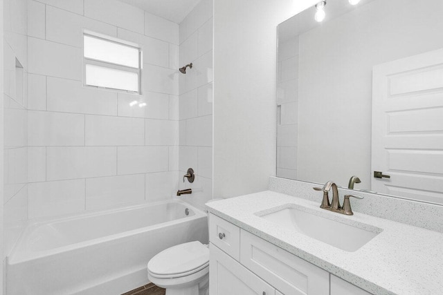 bathroom featuring vanity, shower / bathing tub combination, and toilet