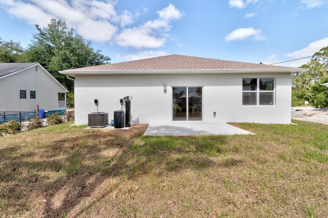 back of house featuring a yard, a patio, fence, and central air condition unit