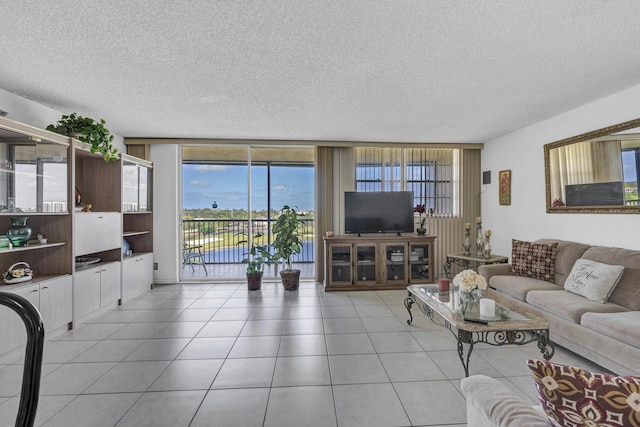 living room featuring a textured ceiling, light tile patterned floors, and a healthy amount of sunlight