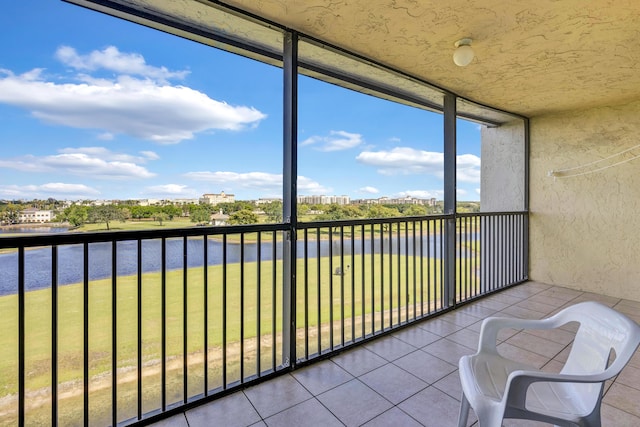 unfurnished sunroom with a water view
