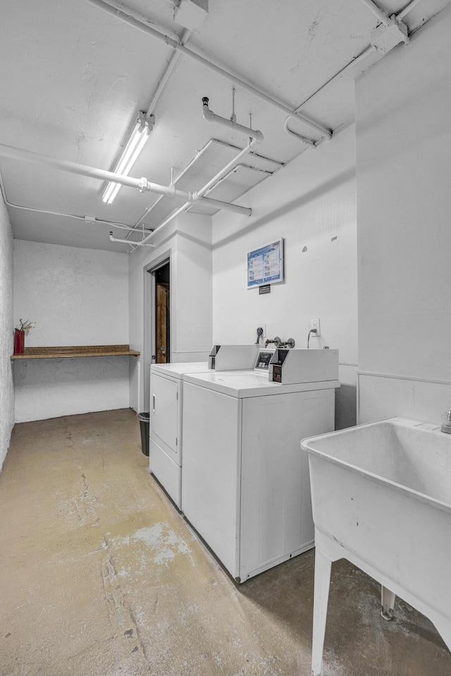 common laundry area featuring washer and clothes dryer and a sink