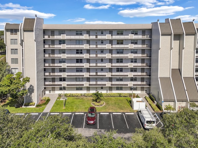 view of property featuring uncovered parking