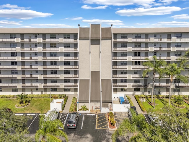 view of building exterior featuring uncovered parking