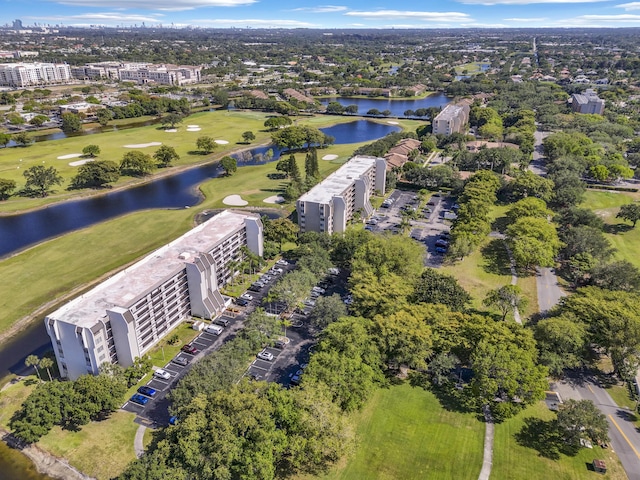 birds eye view of property with a water view and golf course view
