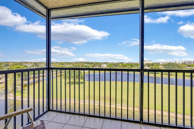 unfurnished sunroom with a water view and a healthy amount of sunlight
