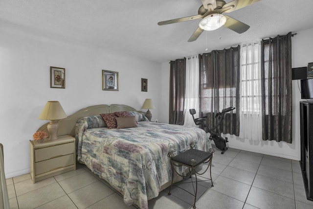 bedroom with baseboards, a ceiling fan, and light tile patterned floors