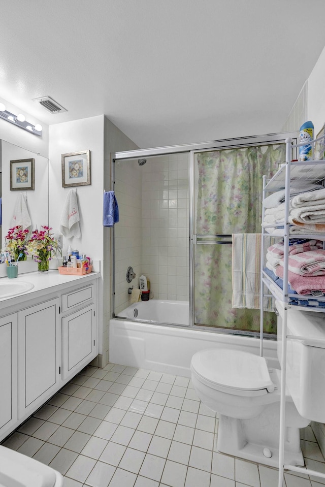 full bath featuring visible vents, tile patterned floors, bath / shower combo with glass door, vanity, and toilet