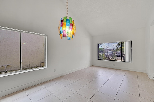 tiled spare room with vaulted ceiling