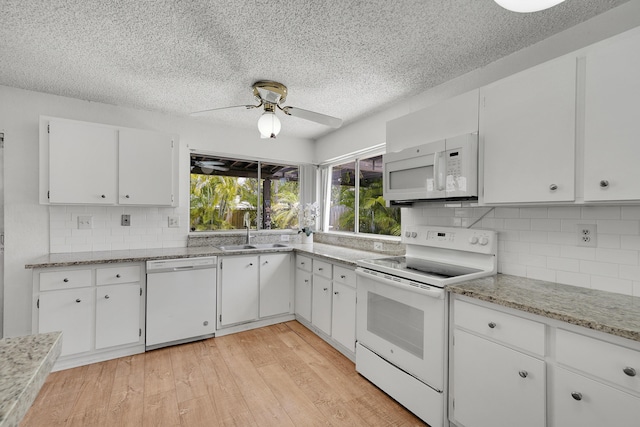 kitchen featuring a sink, white appliances, a textured ceiling, a ceiling fan, and white cabinetry