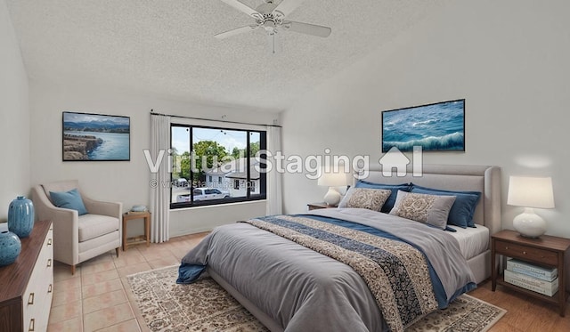 bedroom featuring light tile patterned floors, a ceiling fan, and a textured ceiling
