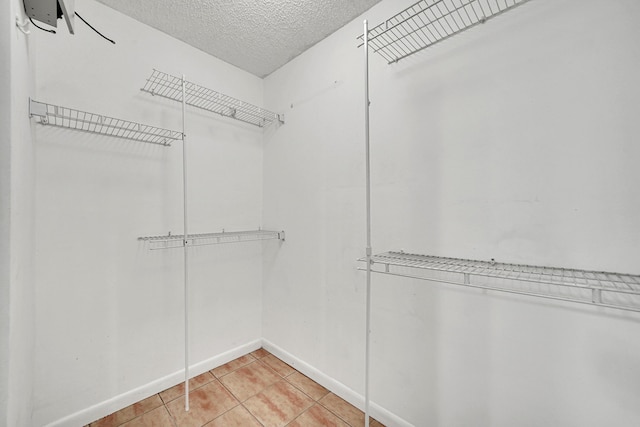 spacious closet featuring light tile patterned floors