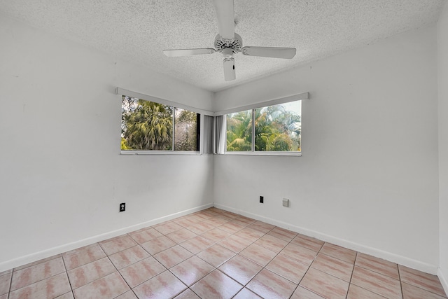 unfurnished room with baseboards, light tile patterned flooring, a textured ceiling, and ceiling fan