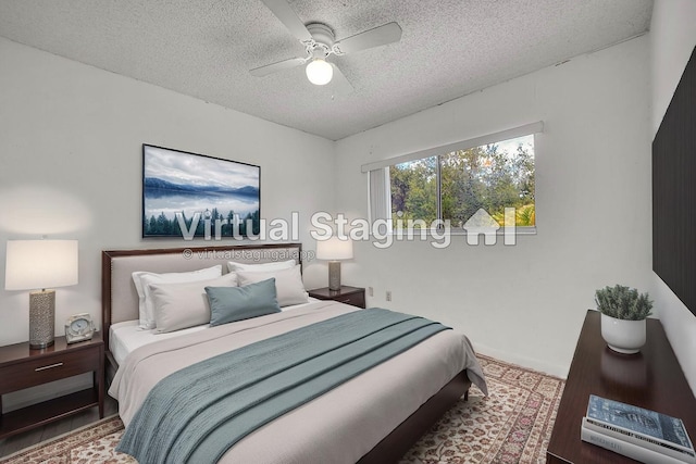 bedroom with a ceiling fan, a textured ceiling, and wood finished floors