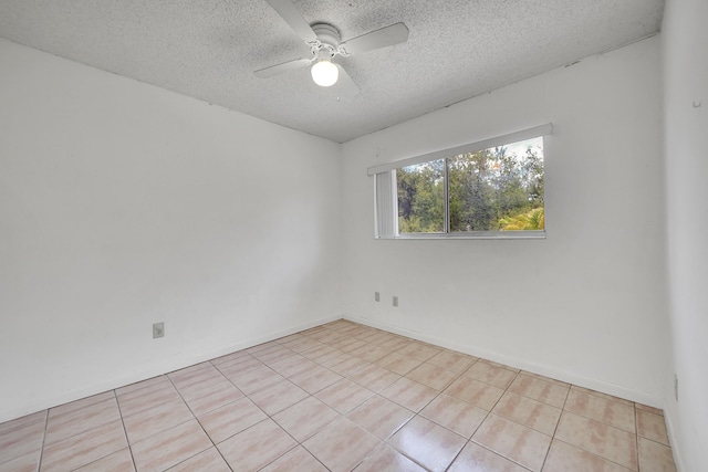 unfurnished room with a textured ceiling, ceiling fan, and tile patterned floors