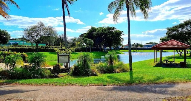 view of home's community featuring a gazebo, a water view, and a yard