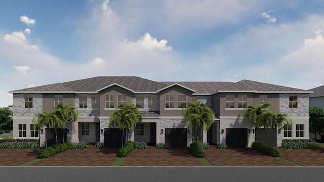 townhome / multi-family property featuring decorative driveway, stucco siding, and stone siding