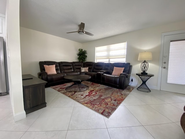 tiled living room with a ceiling fan