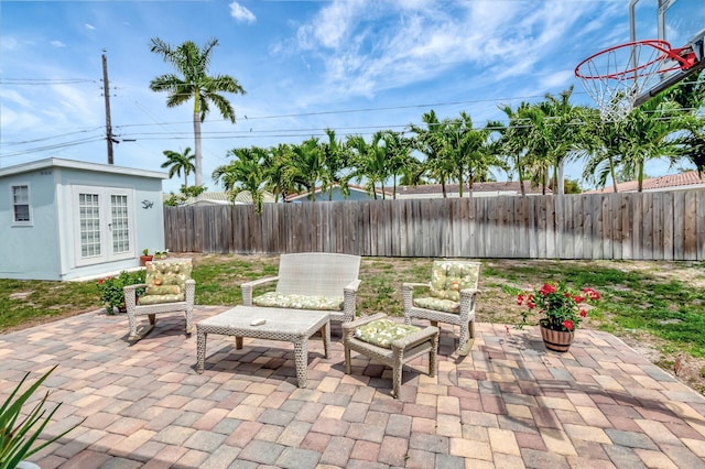 1065 SW 13th St, Boca Raton, FL 33486 - view of patio / terrace featuring a fenced backyard, french doors, outdoor lounge area, and an outbuilding