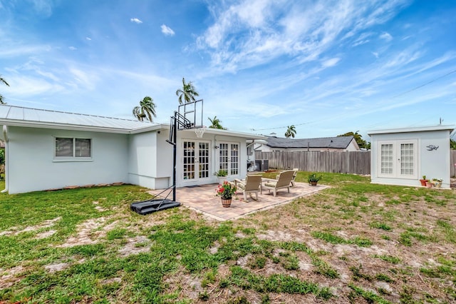 1065 SW 13th St, Boca Raton, FL 33486 - rear view of house featuring french doors, a lawn, a patio area, fence, and stucco siding