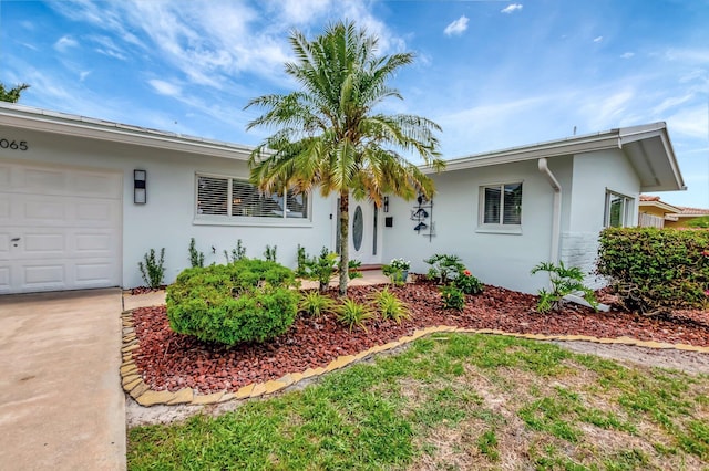 1065 SW 13th St, Boca Raton, FL 33486 - ranch-style house with an attached garage and stucco siding