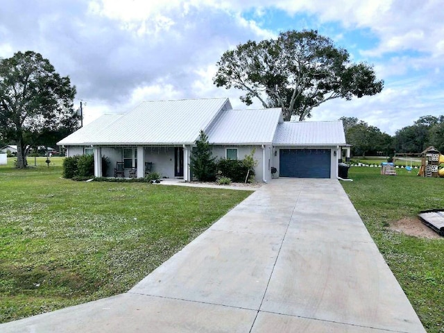 603 NW 11th Ave, Okeechobee, FL 34972 - view of front of property with an attached garage, concrete driveway, a front yard, and metal roof