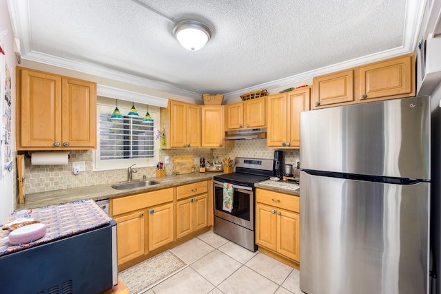 1501 NE 13th Ter Unit H-9, Jensen Beach, FL 34957 - kitchen with crown molding, appliances with stainless steel finishes, a sink, tasteful backsplash, and under cabinet range hood