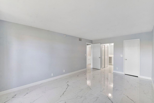 9960 Pineapple Tree Dr Unit 107, Boynton Beach, FL 33436 - unfurnished bedroom featuring baseboards, visible vents, connected bathroom, and marble finish floor