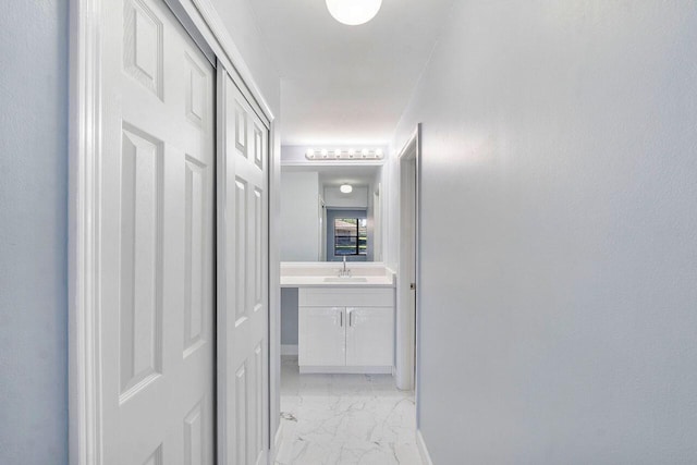 9960 Pineapple Tree Dr Unit 107, Boynton Beach, FL 33436 - hall with baseboards, a sink, and marble finish floor