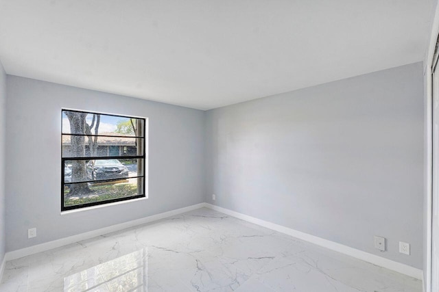 9960 Pineapple Tree Dr Unit 107, Boynton Beach, FL 33436 - spare room featuring baseboards and marble finish floor
