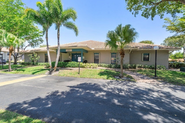 9960 Pineapple Tree Dr Unit 107, Boynton Beach, FL 33436 - single story home with a tile roof, a front yard, and stucco siding