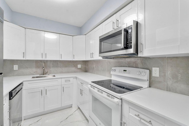 9960 Pineapple Tree Dr Unit 107, Boynton Beach, FL 33436 - kitchen with appliances with stainless steel finishes, a sink, light countertops, white cabinets, and marble finish floor