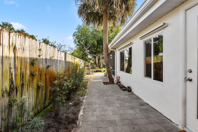 1225 15th Ave N, Lake Worth Beach, FL 33460 - view of home's exterior featuring fence, stucco siding, and a patio area